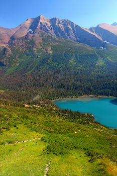 Grinnell Lake amidst the majestic mountain scenery of Glacier National Park in Montana.