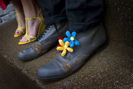 Image of a pair of Grungy shoes with flower decorations and a second pair of yellow wedges in background