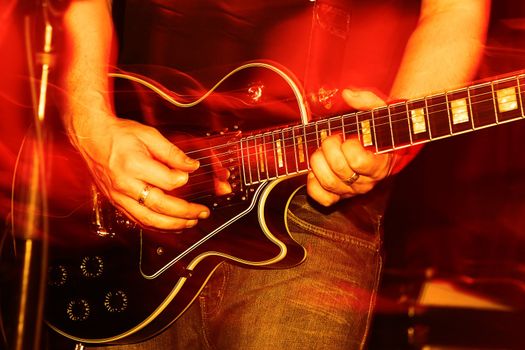 closeup of an guitarist at a rock concert, motioneffect!