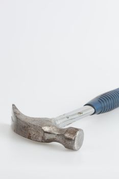 Old and rusty hammer with blue handle