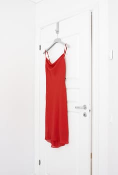Red Dress hanging on a door