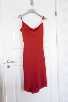 Red Dress hanging on a door