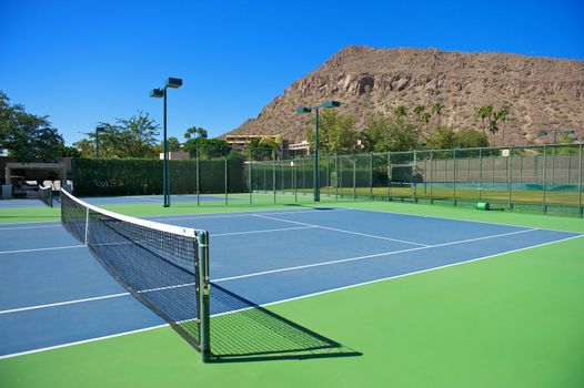 Horizontal shot of a blue surfaced tennis court