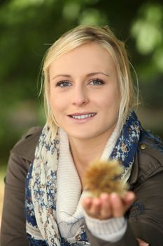 Woman holding a spiky chestnut case