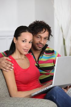 Couple at home using a laptop computer