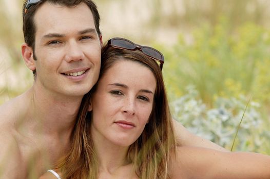 Couple sat in a remote field in summer