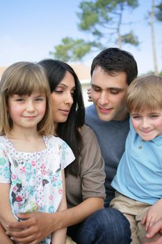 Family sat together in the garden