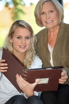 Mother and daughter looking through photo album