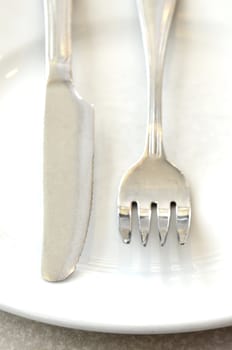 Spoon and knife on white dish