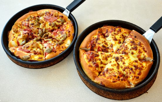 Pizza in the hot pan, Meat pizza and cheese pizza.