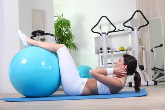 Woman doing sit-ups with gym ball