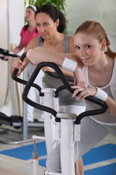 Young women using exercise equipment