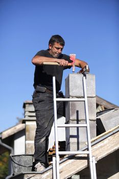 Builder constructing a chimney