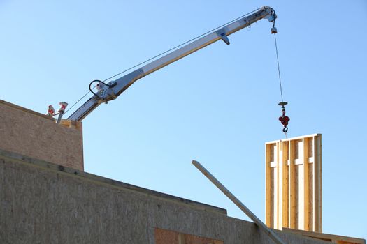 Crane lifting wooden wall