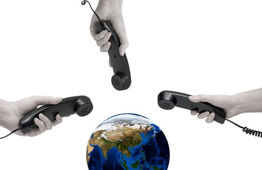 World Communication on white. office black telephones with hands connecting to world