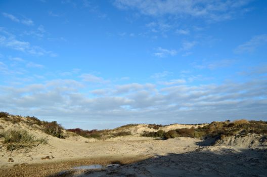 Clouds over a dune landscape with sand and grass near The Hague in Holland.