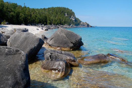 A stone rock beach on a stretch of lake shore known as Halfway Log Dump, Lake Huron, Ontario.
