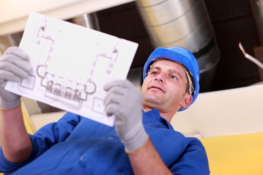 Man looking at plans for a heating installation