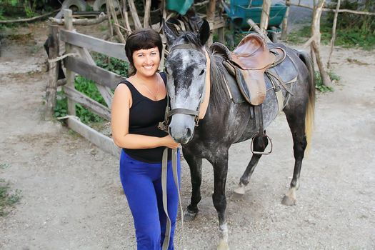 Portrait happy smiling woman with grey horse