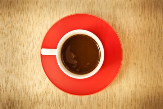 red cup of hot coffee on wood background