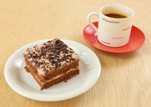 chocolate cake and coffee on wood background