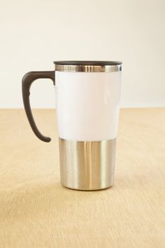 metal cup on wood background