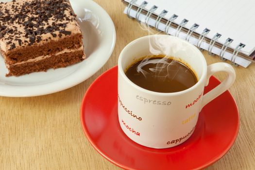 chocolate cake and coffee on wood background