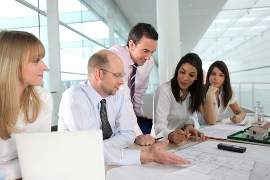 A team of architects discussing a drawing