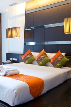 Hotel room in a tropical resort with bed and wooden flooring