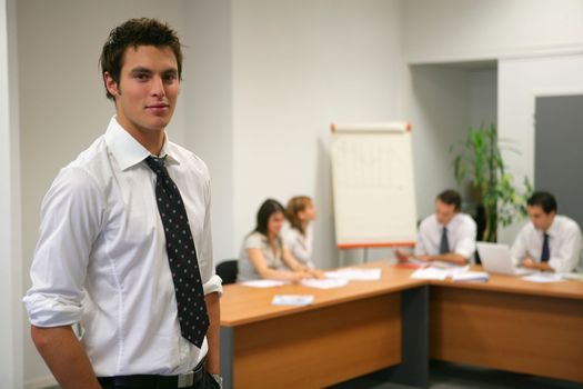 Young businessman about to give presentation to executives