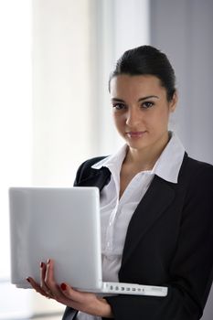 Brunette businesswoman holding laptop