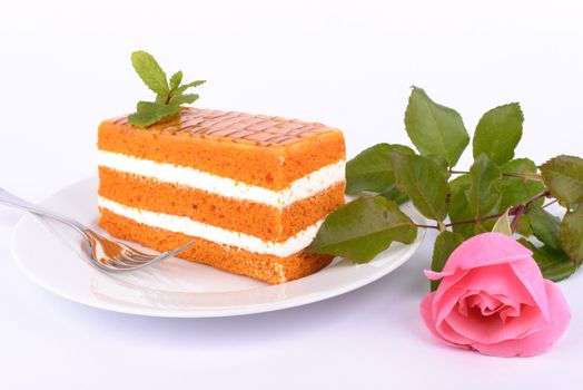 Carrot cake on the plate with mint branch.