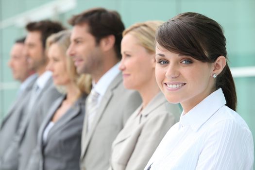 Line up of employees with the youngest in focus