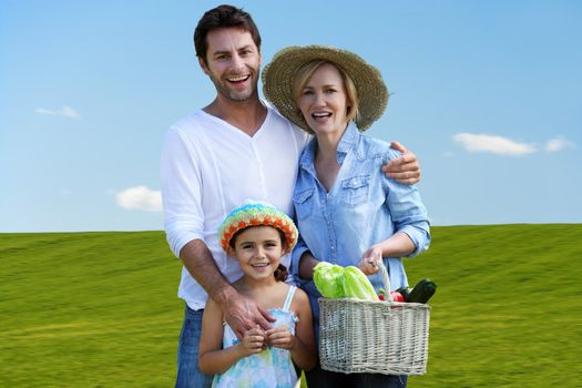 Parents with daughter on green grass background