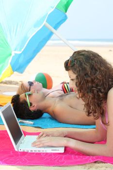 Three teenage friends relaxing at the beach