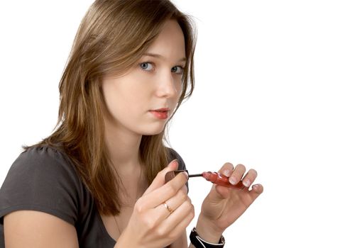 The girl painting lips isolated on a white background