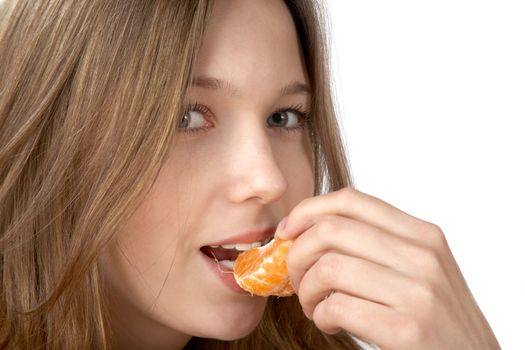 The girl  eats  tangerine on  white background
