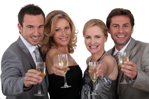 Four people toasting success