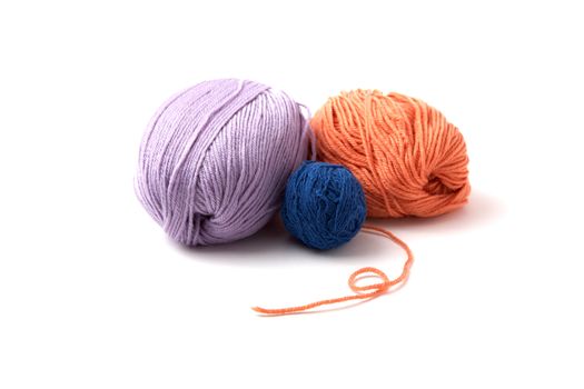 Balls of a multi-coloured yarn on  white background