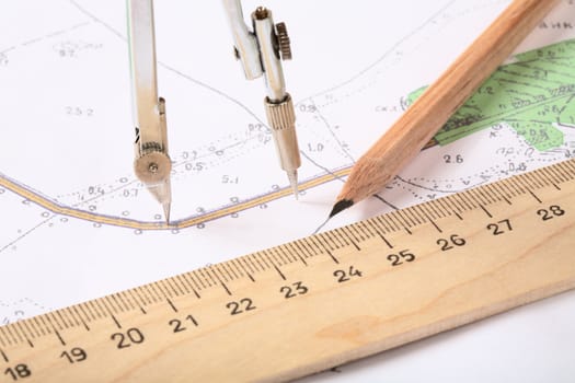 Topographic map of district with  measuring instrument,  ruler and a pencil