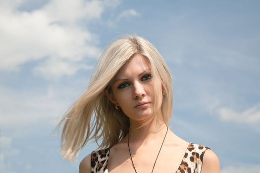beautiful girl on a background of the blue sky