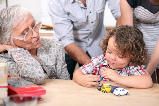 Little boy playing with toy cars