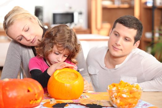 Family carving pumpkins