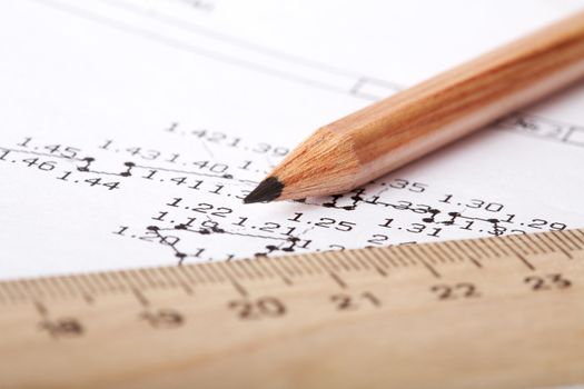 wooden ruler and pencil lay on the drawing