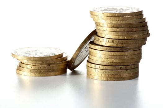 Pile of yellow metal coins on a textural background
