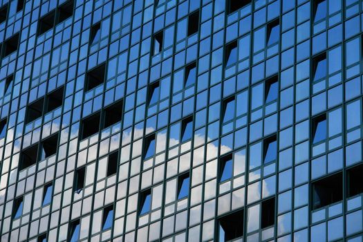 Clouds and sky reflecting in a modern office building..............