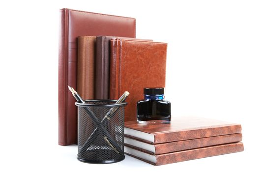 Business still-life with organizers pens and ink isolated on a white background