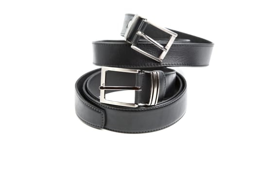 Two man's black belts on a white background