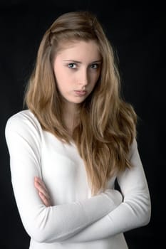 Portrait of the serious girl on a black background