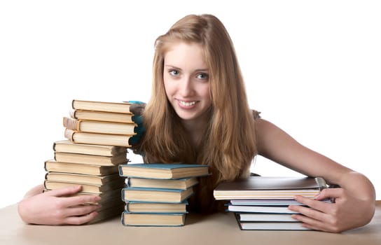 The girl embraces a pile of books and writing-books on  white background